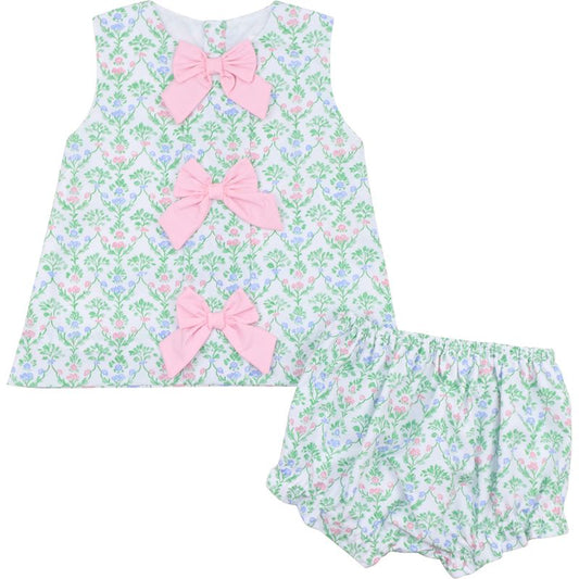 Floral baby outfit with pink bows on a white background