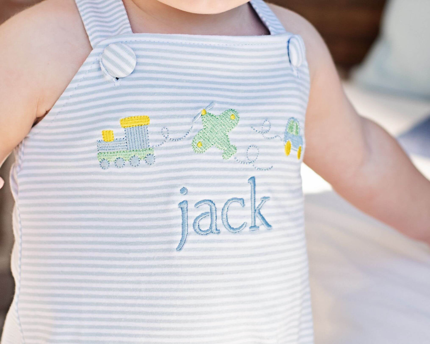 Blue Striped Bubble With Embroidered Train, Car And Airplane And Monogram On The Front
