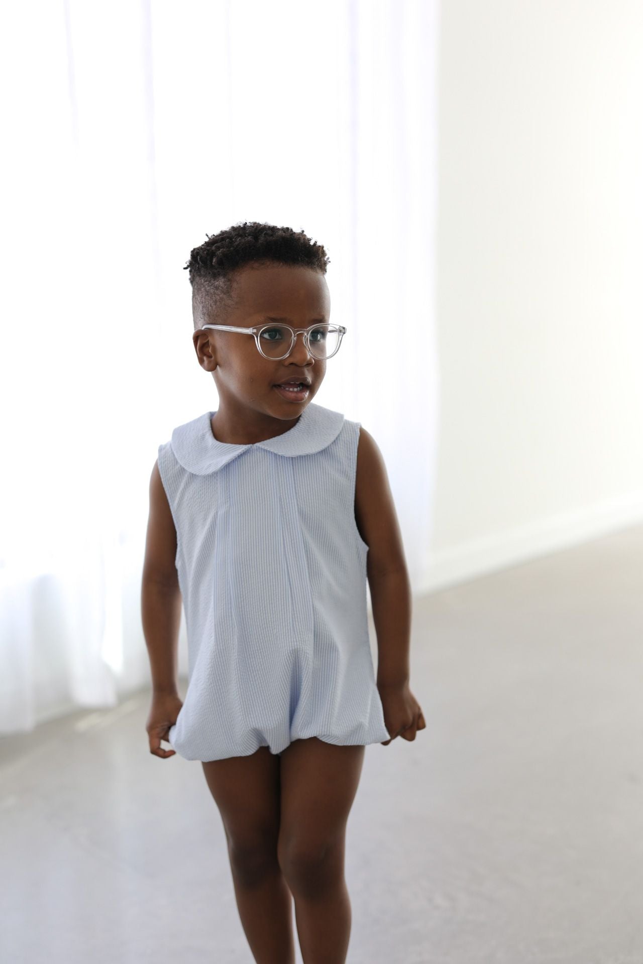 Boy wearing a striped bubble and glasses