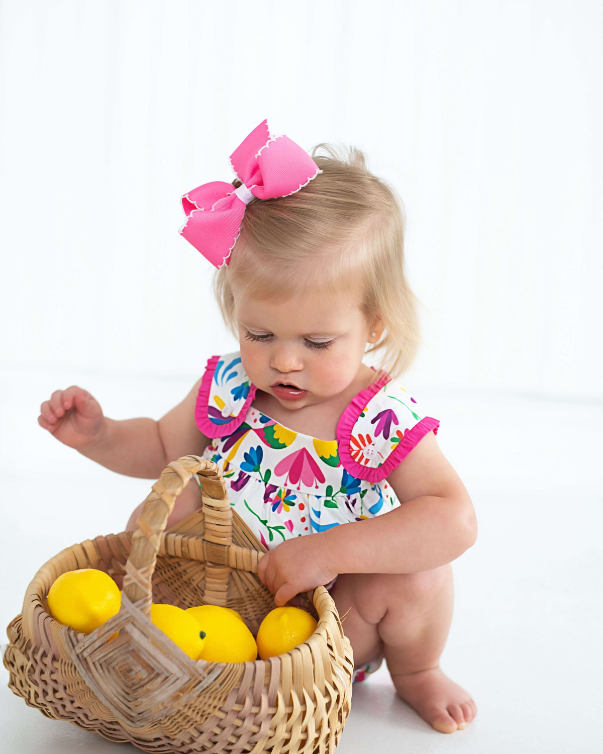 Child playing with a basket of toys on a white background