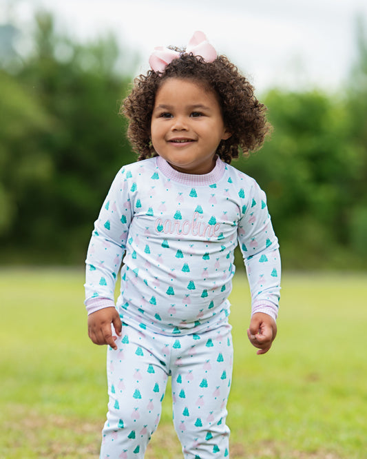 Child wearing a light blue outfit with cloud pattern outdoors