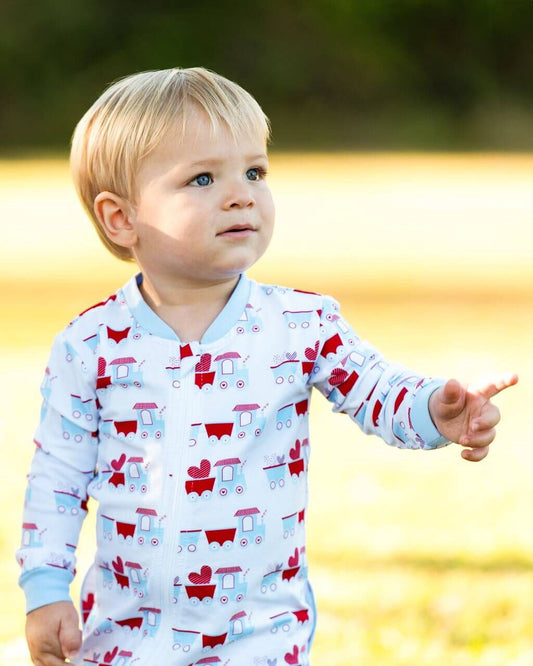 Child wearing pajamas with train pattern outdoors