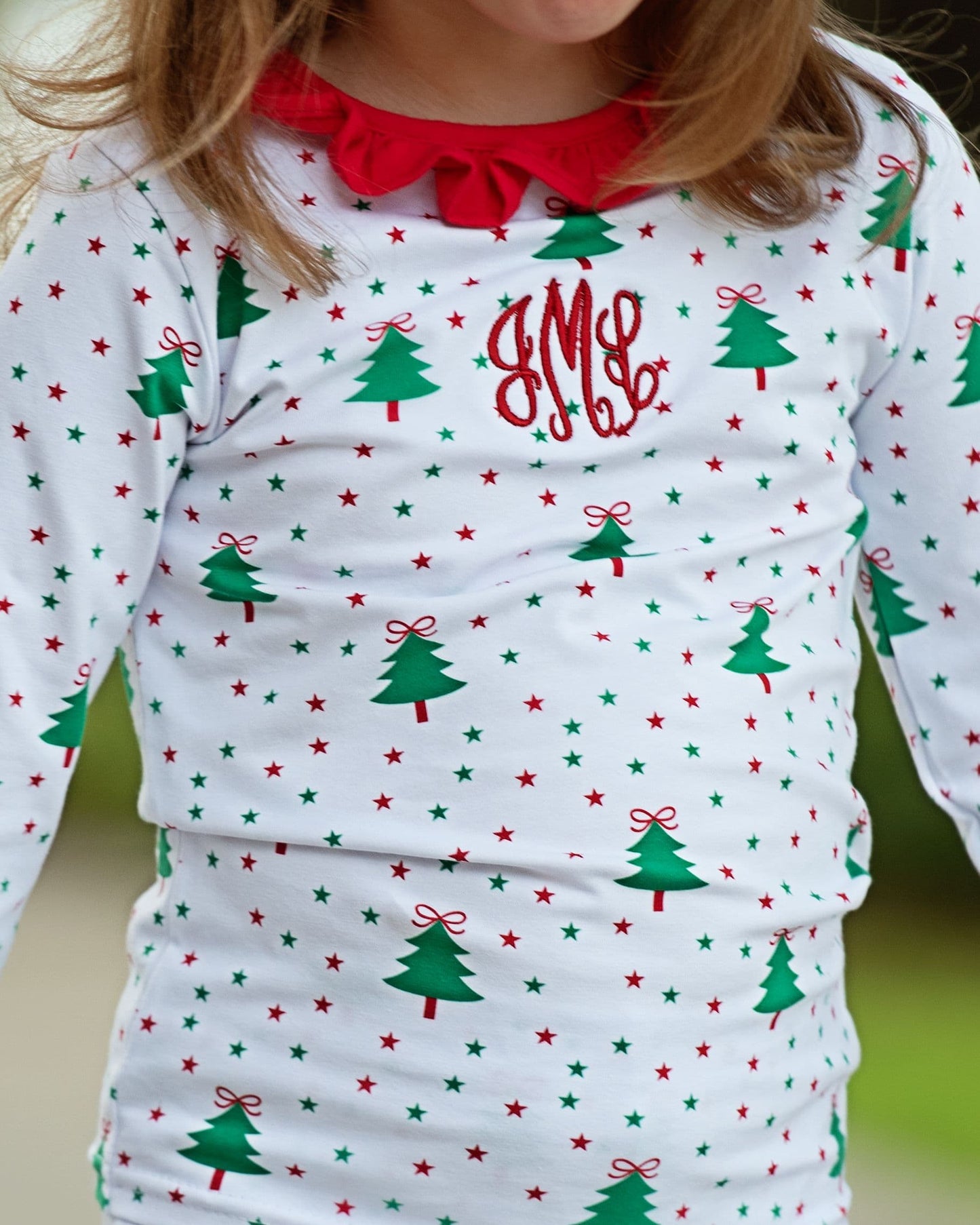 Children's long-sleeve shirt with Christmas tree and star pattern on a white background