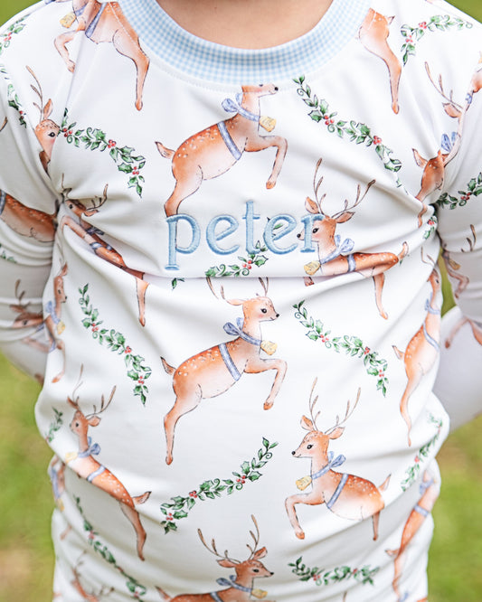 Children's outfit with deer pattern and 'peter' text on a white background
