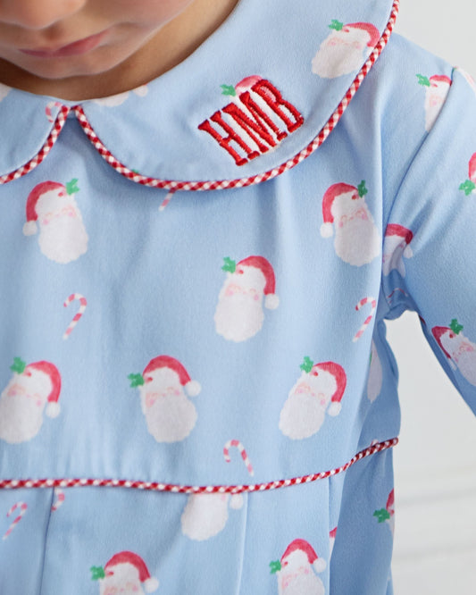 Children's pajama with Santa Claus pattern and 'Him' text on a light blue background