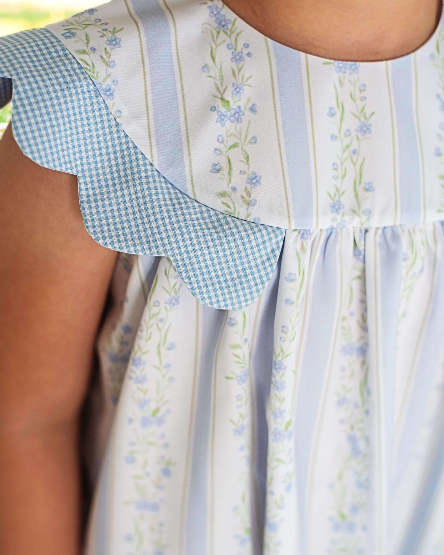 Close-up of a dress with floral and checkered patterns