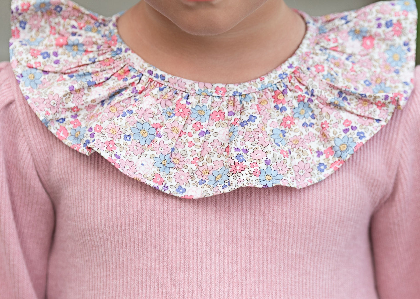 Close-up of a pink bubble with a floral ruffled collar.