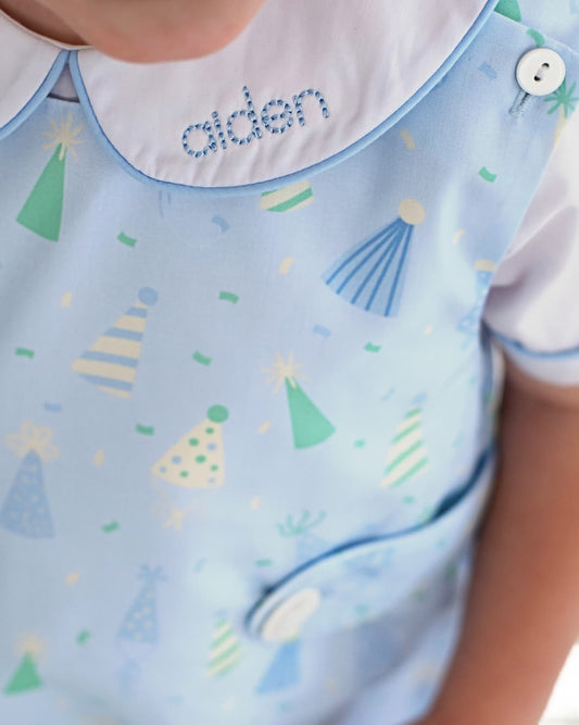 Close up of a birthday outfit and collar showing the name aiden