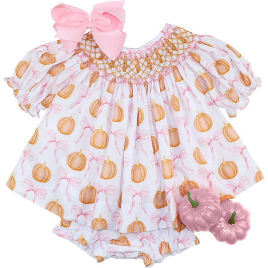 Diaper set with pumpkin pattern and pink bow on a white background