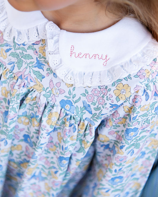 Floral dress with 'henny' embroidered on the collar.