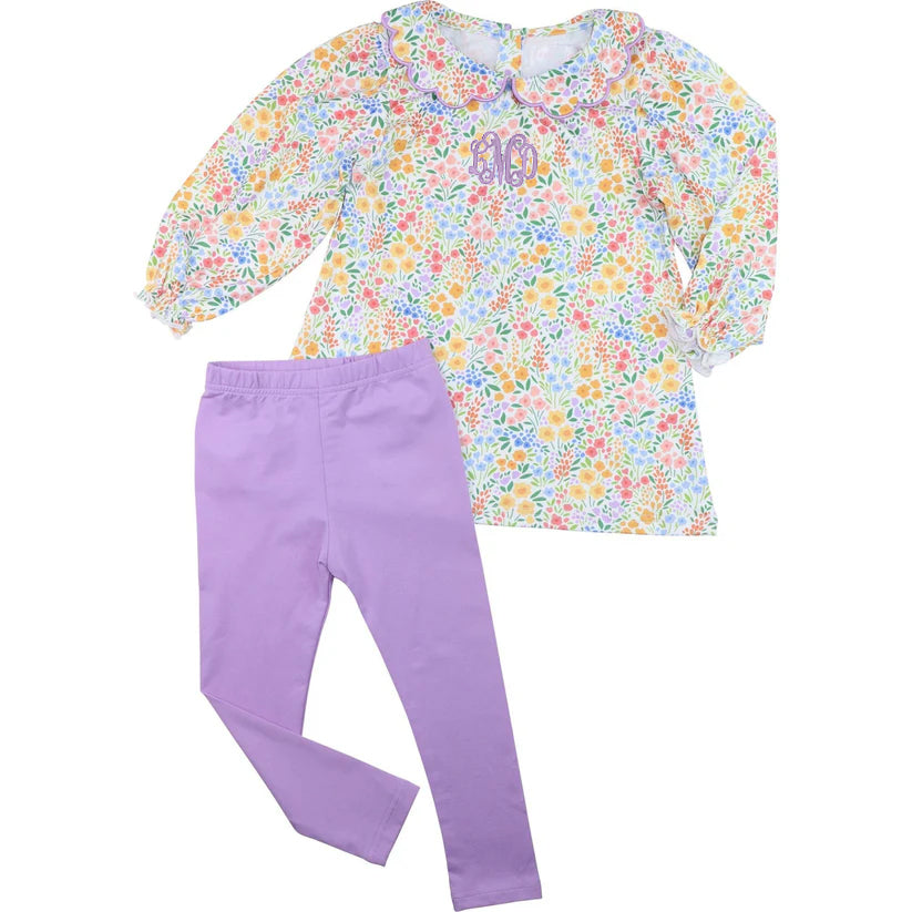 Floral top and purple pants set on a white background