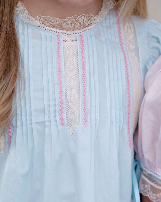 Light blue dress with lace details worn by a person