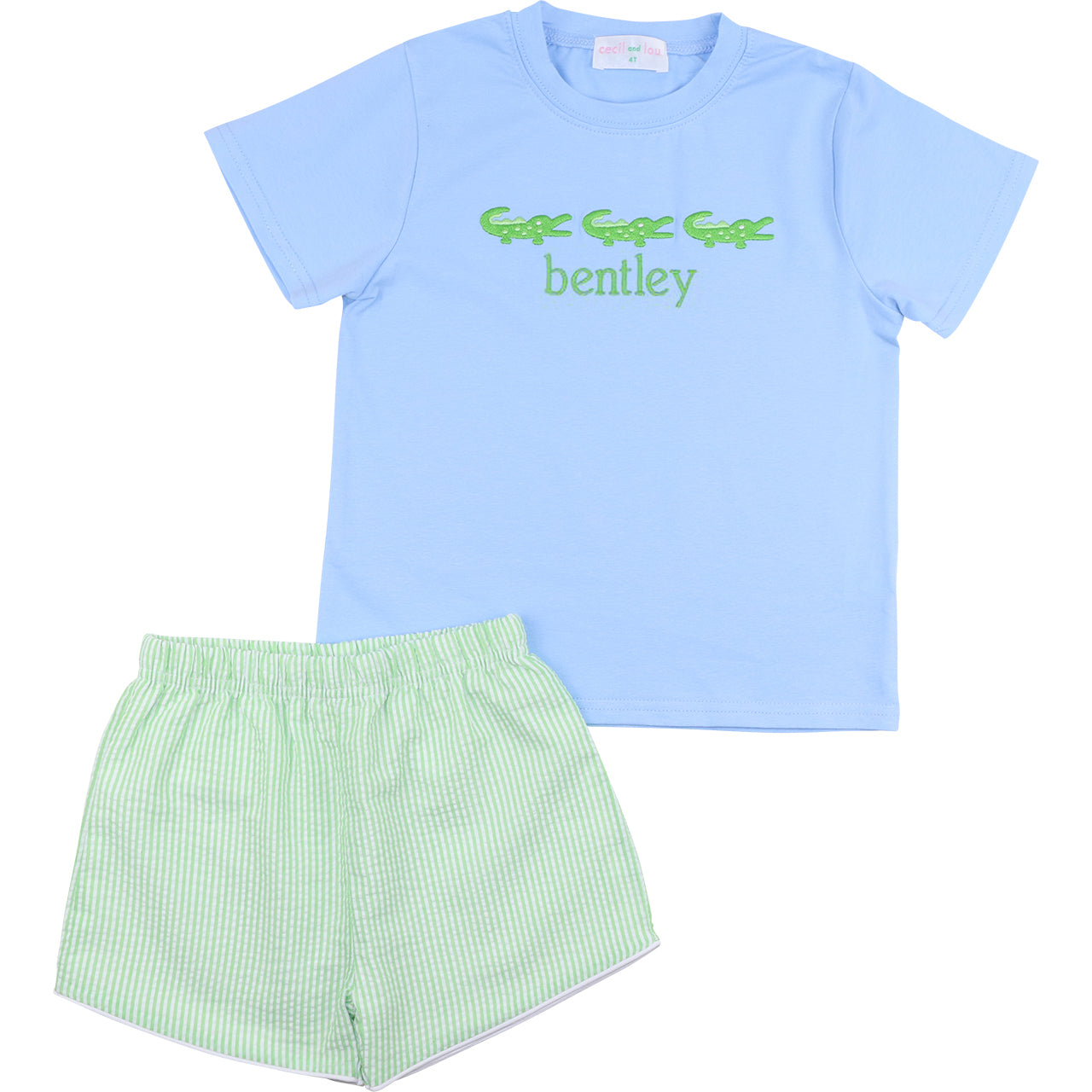 Light blue t-shirt with green text and green shorts on a white background