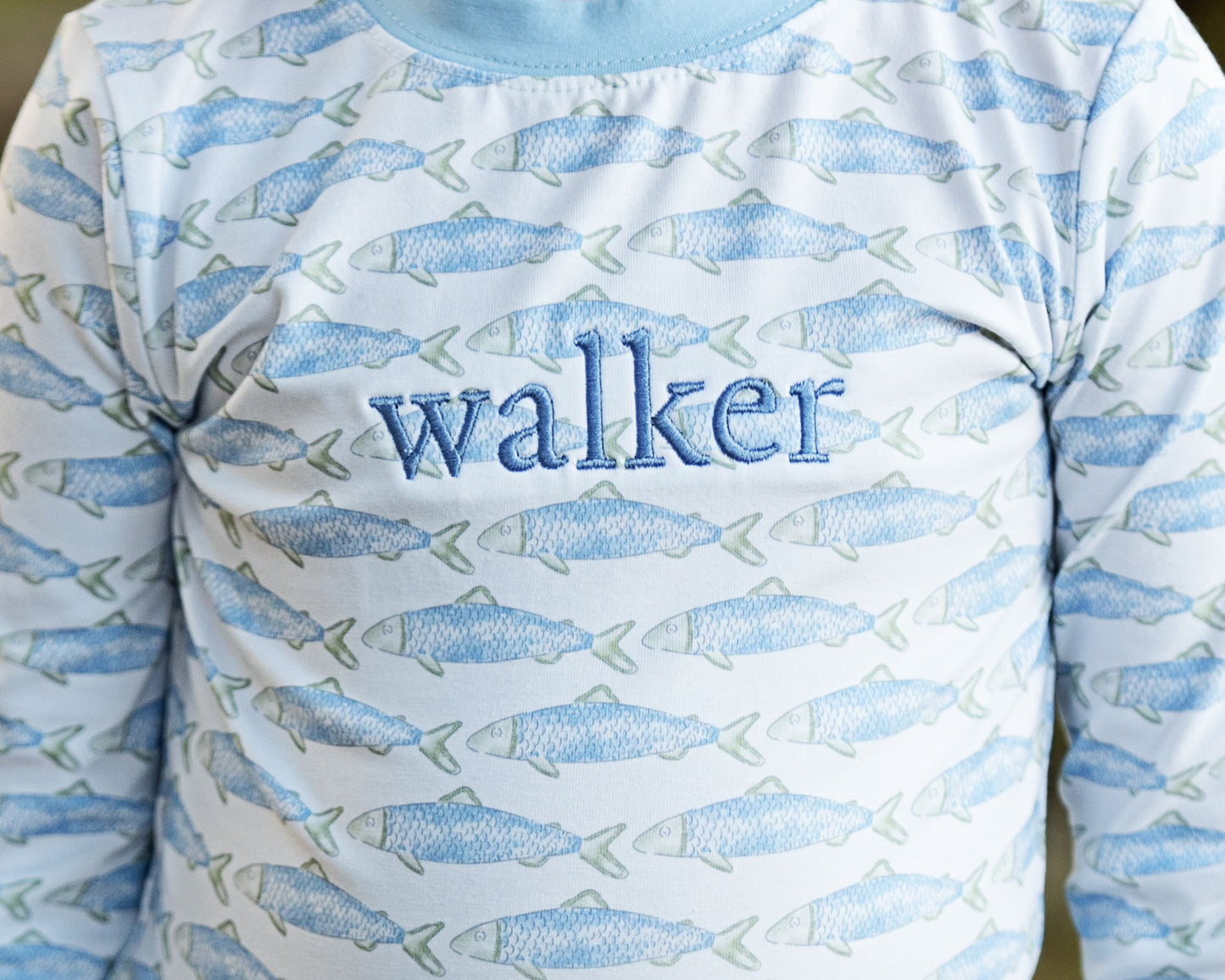 Long-sleeve shirt with fish pattern and 'walker' text on a light blue background
