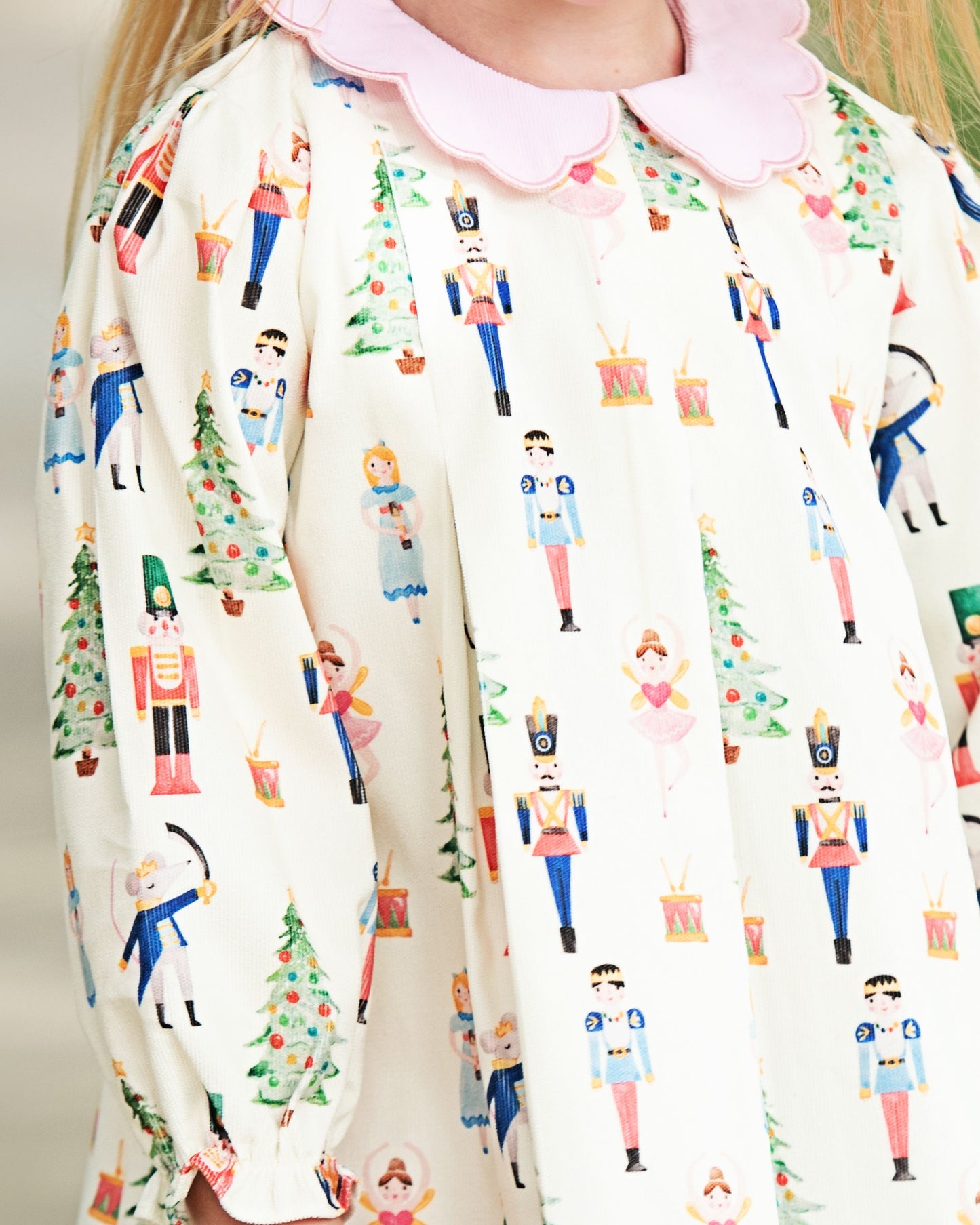 Person wearing a white outfit with festive nutcracker pattern