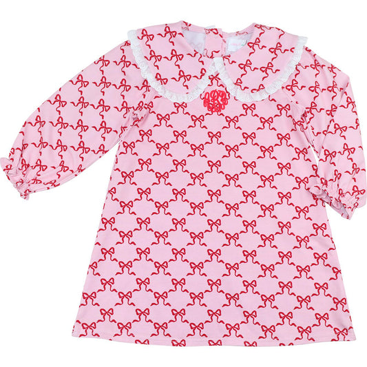 Pink dress with red bow pattern on a white background