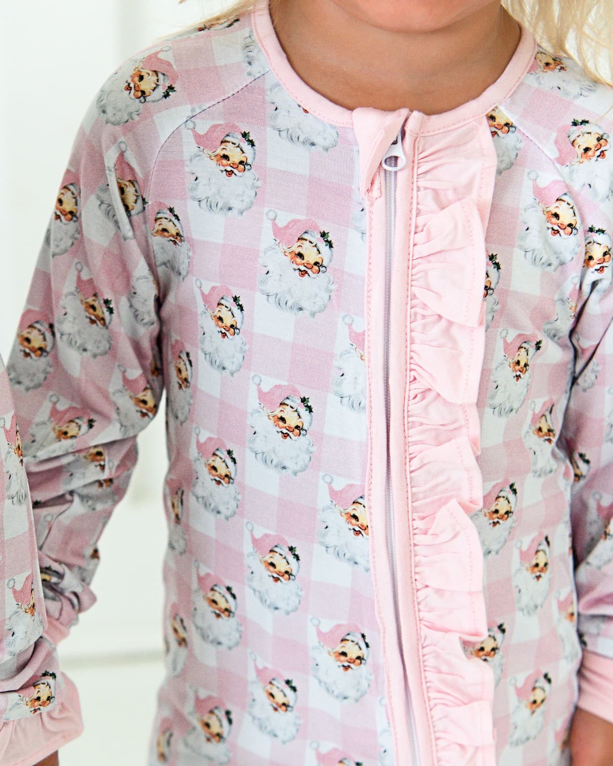 Pink jacket with cartoon character pattern worn by a child