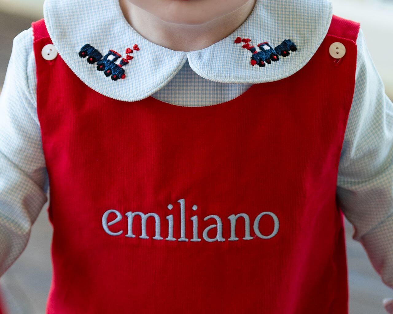 Red long romper with embroidered name 'emiliano' on the collar