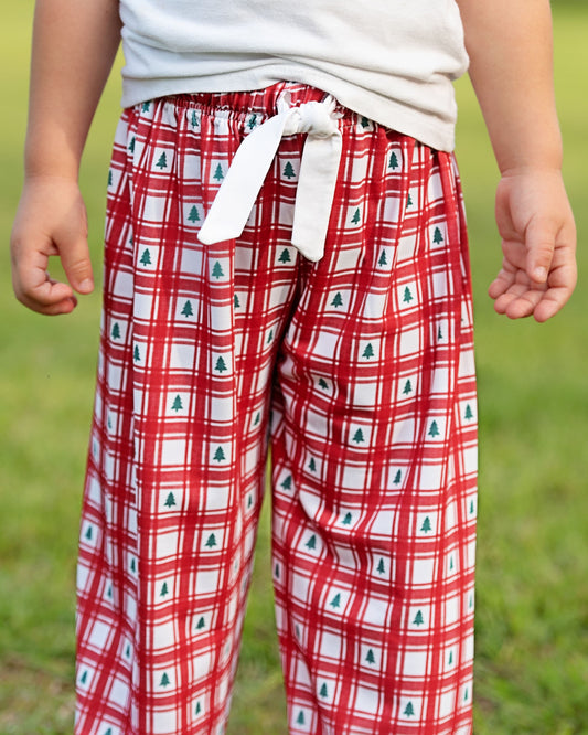 Red plaid pants with green trees on a grassy background