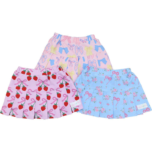Three colorful skirts with different patterns on a white background