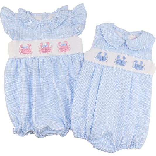 Two baby rompers with crab designs on a white background