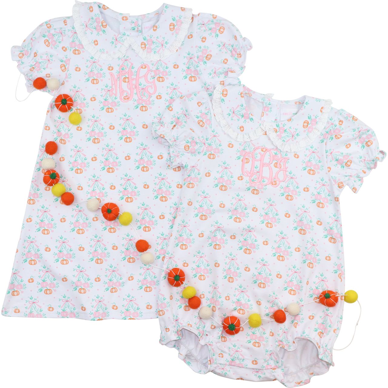 Two baby rompers with floral patterns and colorful pom-poms on a white background