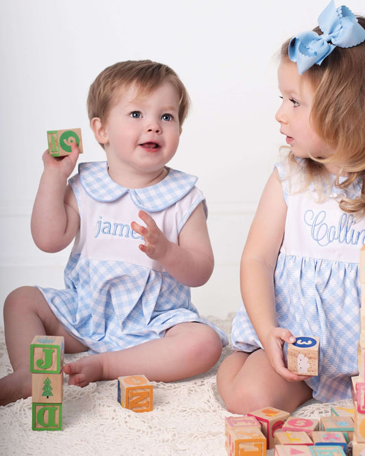 Two children playing with colorful blocks on a white background