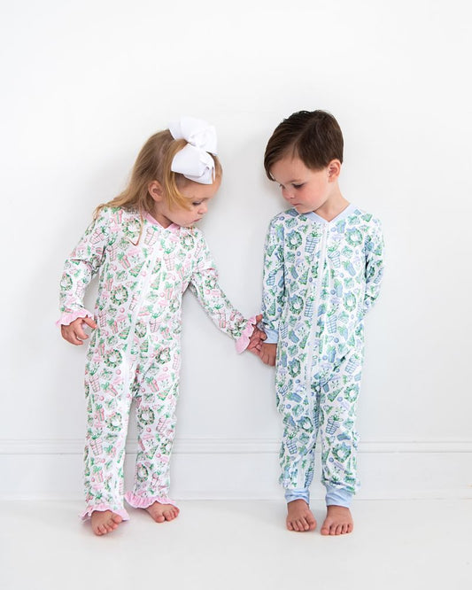 Two children wearing floral pajamas standing against a white background