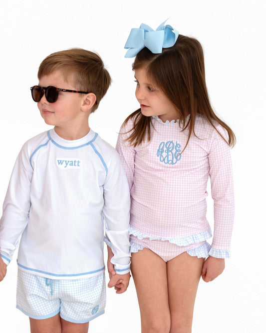 Two children wearing matching outfits with 'wyatt' and 'mona' text on a white background
