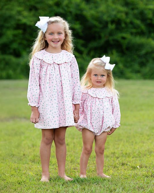 Two girls wearing matching outfits outside
