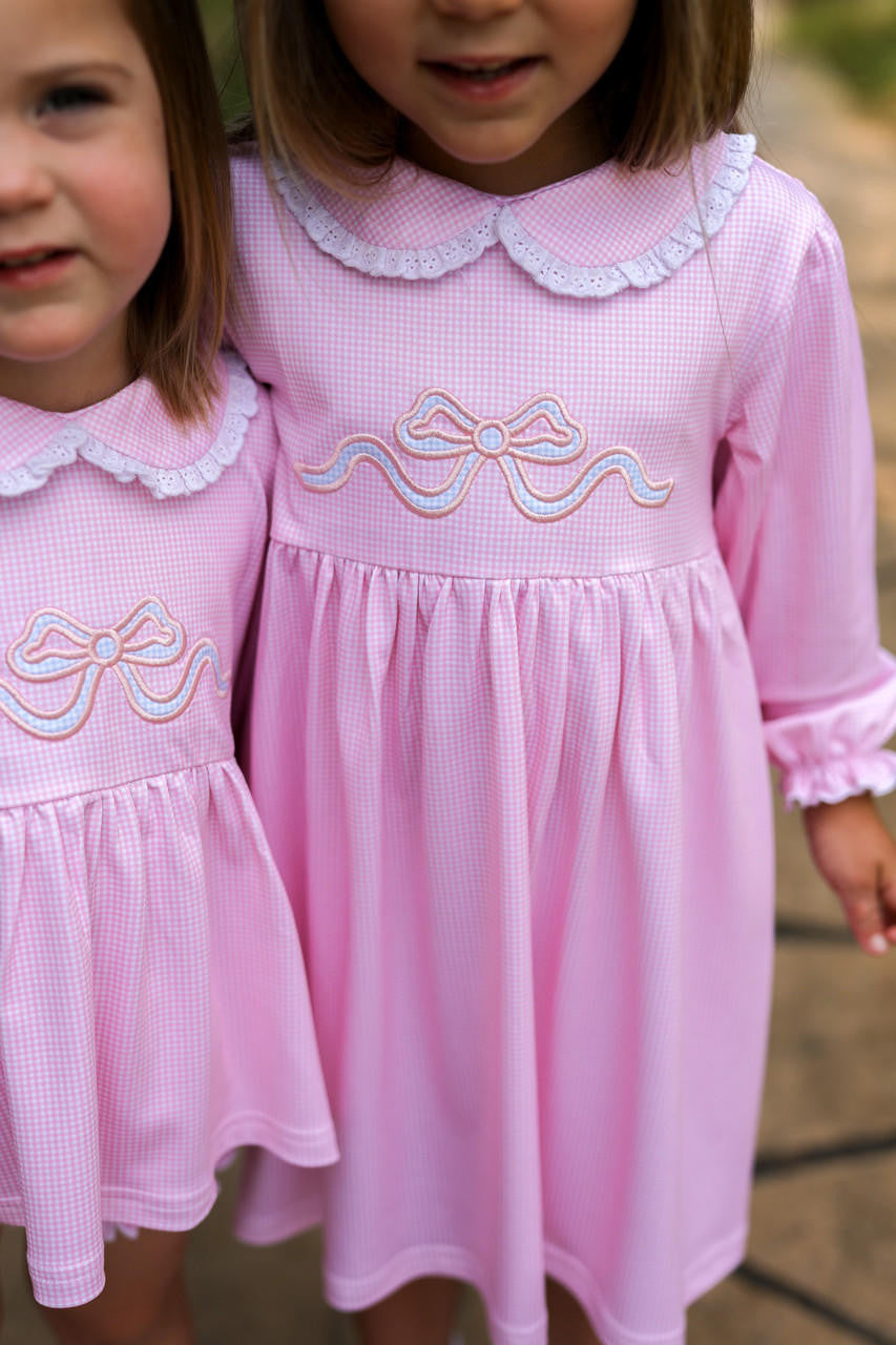Two girls wearing matching pink outfits