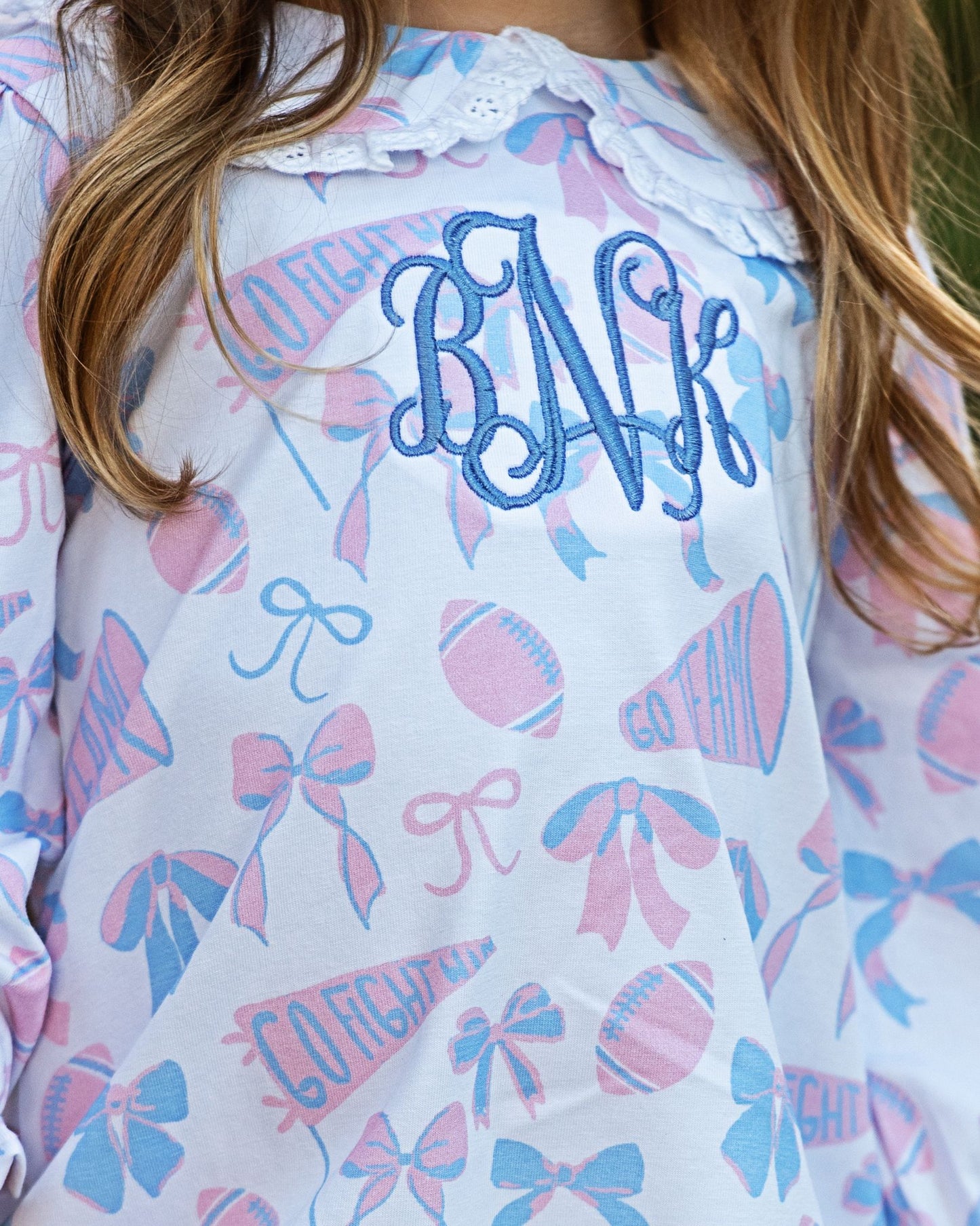 White shirt with blue monogram and pink and blue patterns