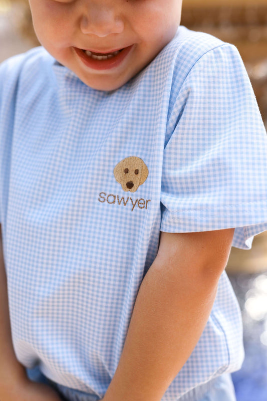 Young boy wearing a blue gingham knit shirt with an embroidered puppy and monogrammed name