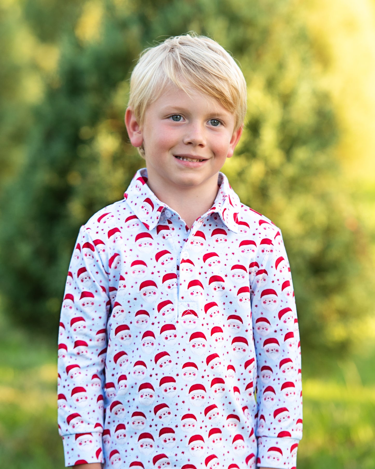 Young boy wearing a patterned shirt with a blurred green background 1