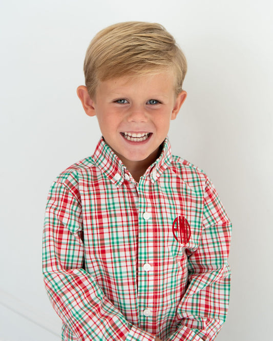 Young boy wearing a red and green checkered shirt with a logo on a white background