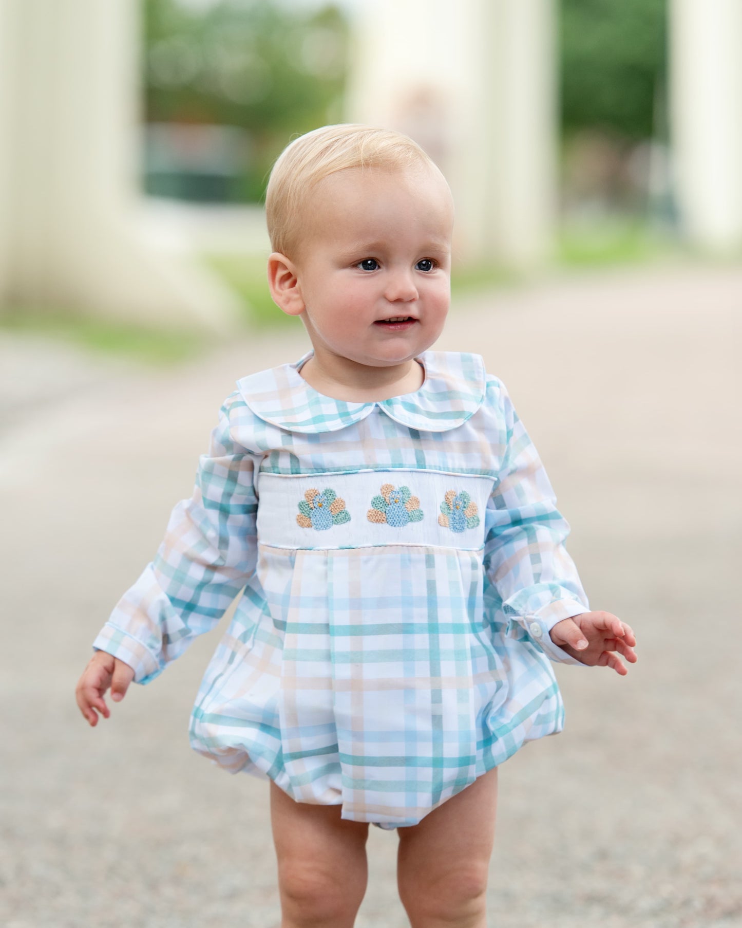 Young boy wearing green and khaki plaid smocked turkey bubble