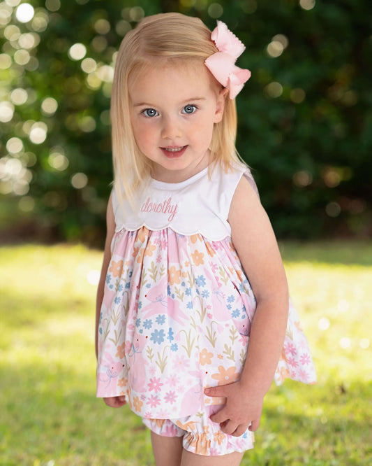 Young girl in a floral dress with a blurred green background