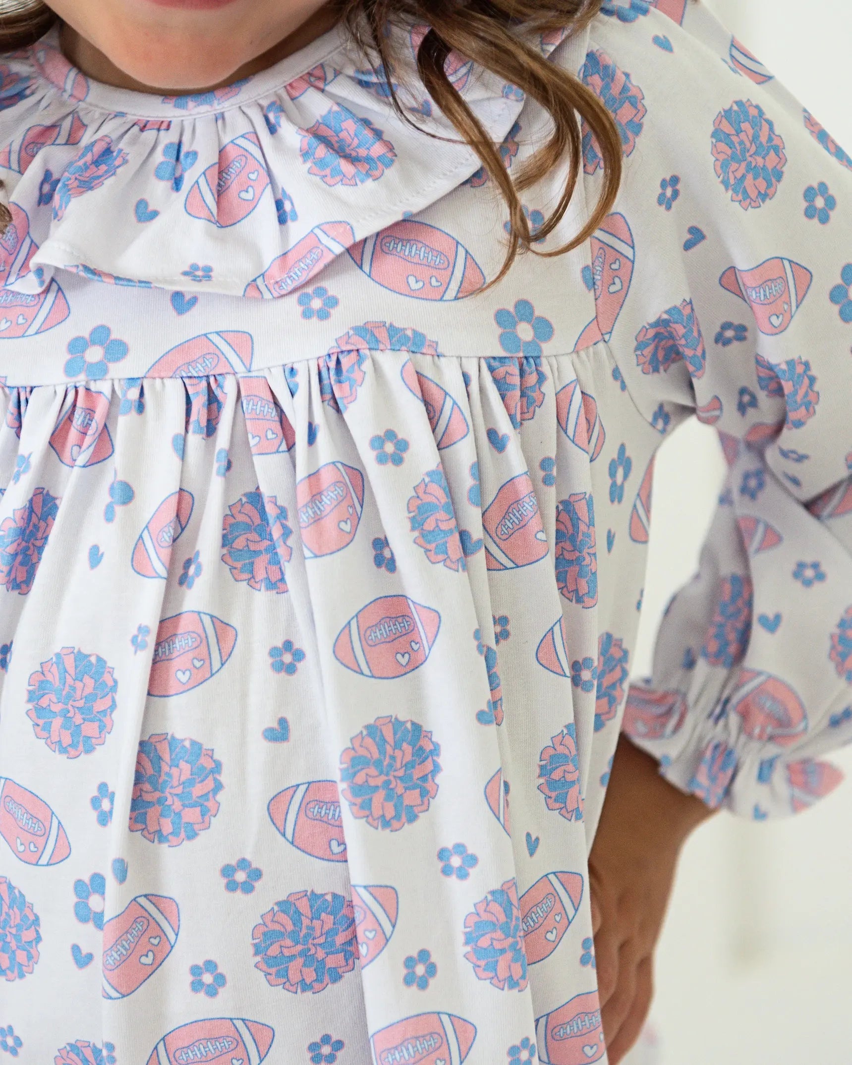Children's dress with football and flower pattern on a white background