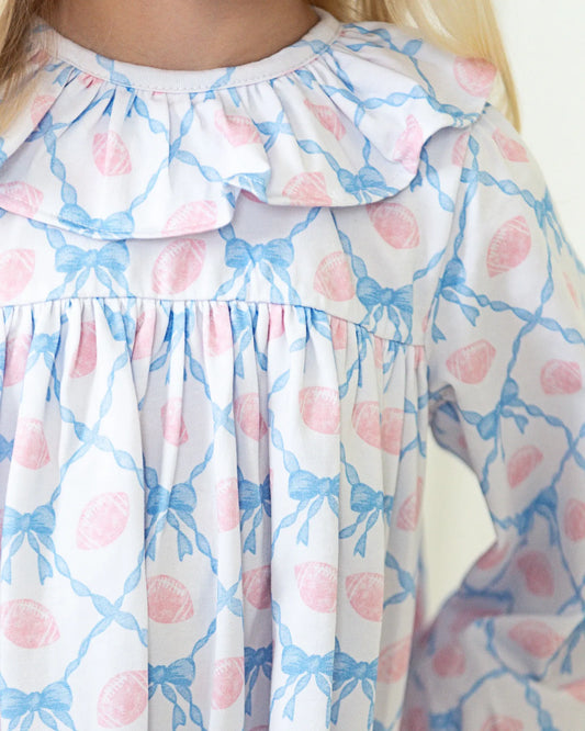 Dress with a floral pattern featuring pink flowers and blue leaves on a white background.