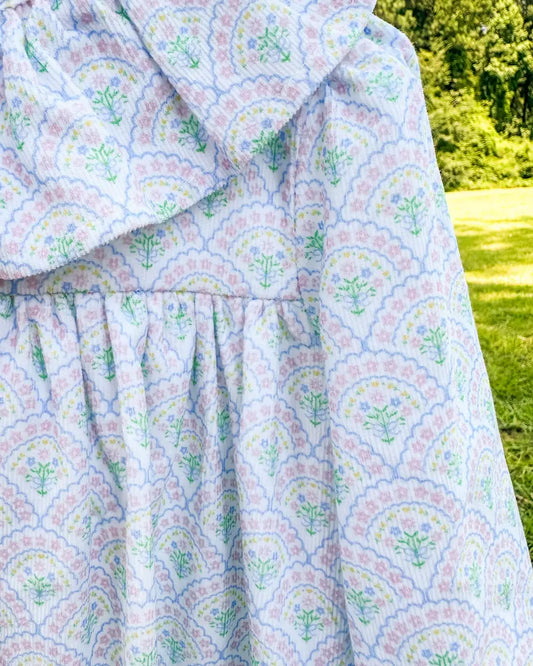 Floral patterned fabric draped over a surface with a natural background