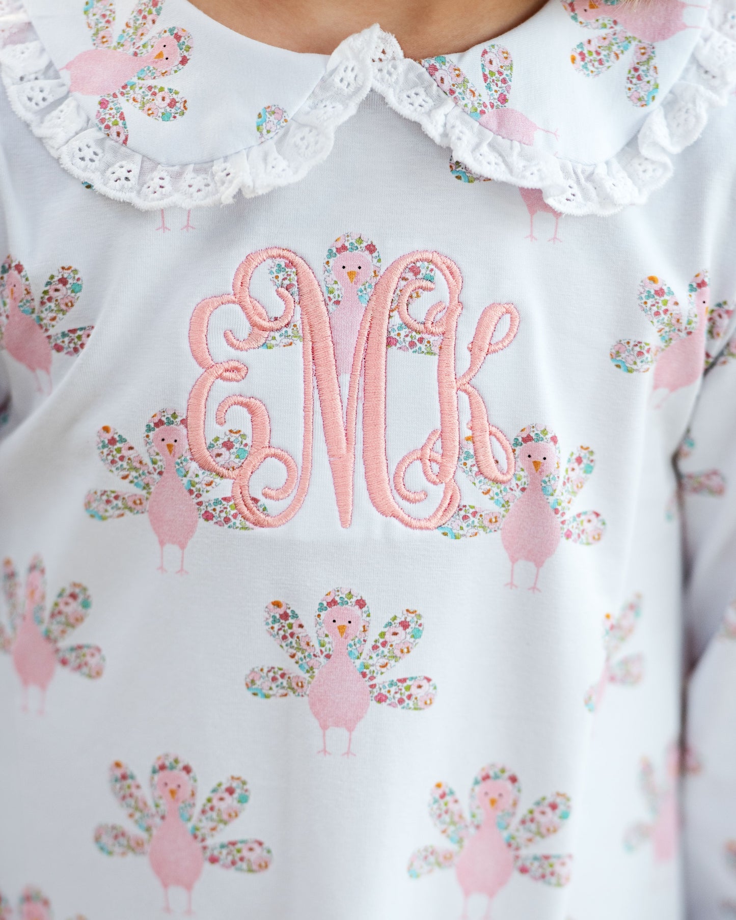 girl outfit with collar, monogrammed "eMk", and turkey pattern.