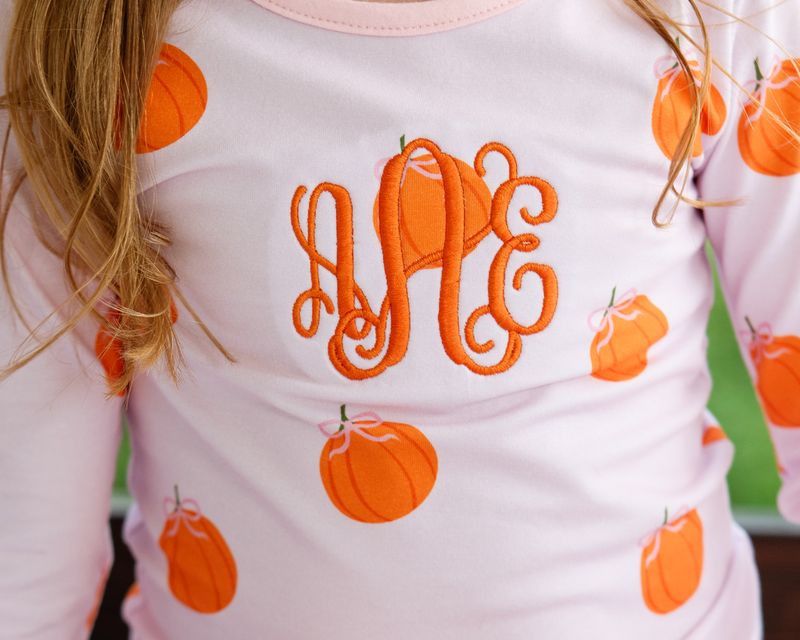 girl pajama set with orange pumpkins and monogram "aAe"