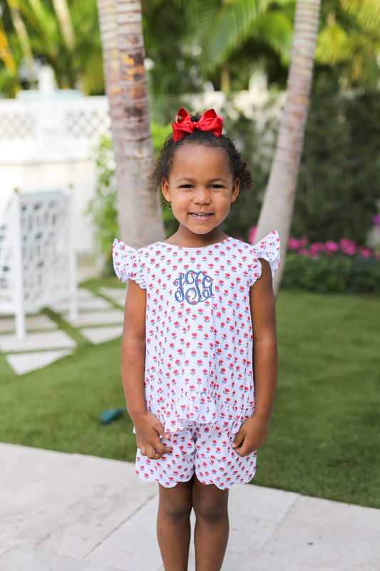 girl wearing a red white and blue set with a red bow