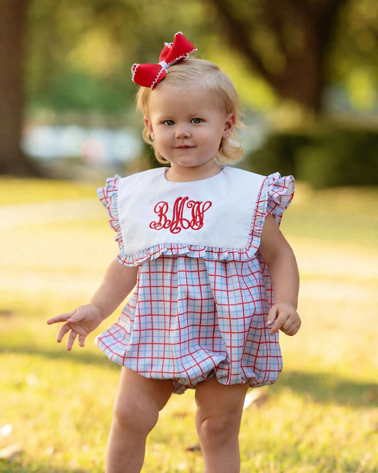 little girl wearing a red and blue bubble
