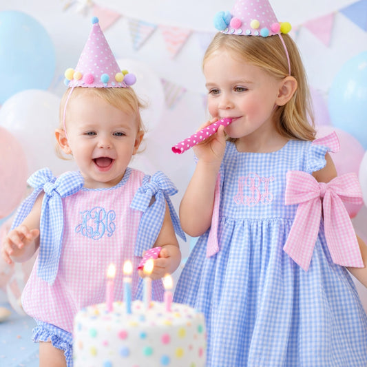 two little girls celebrating a birthday in matching outfits