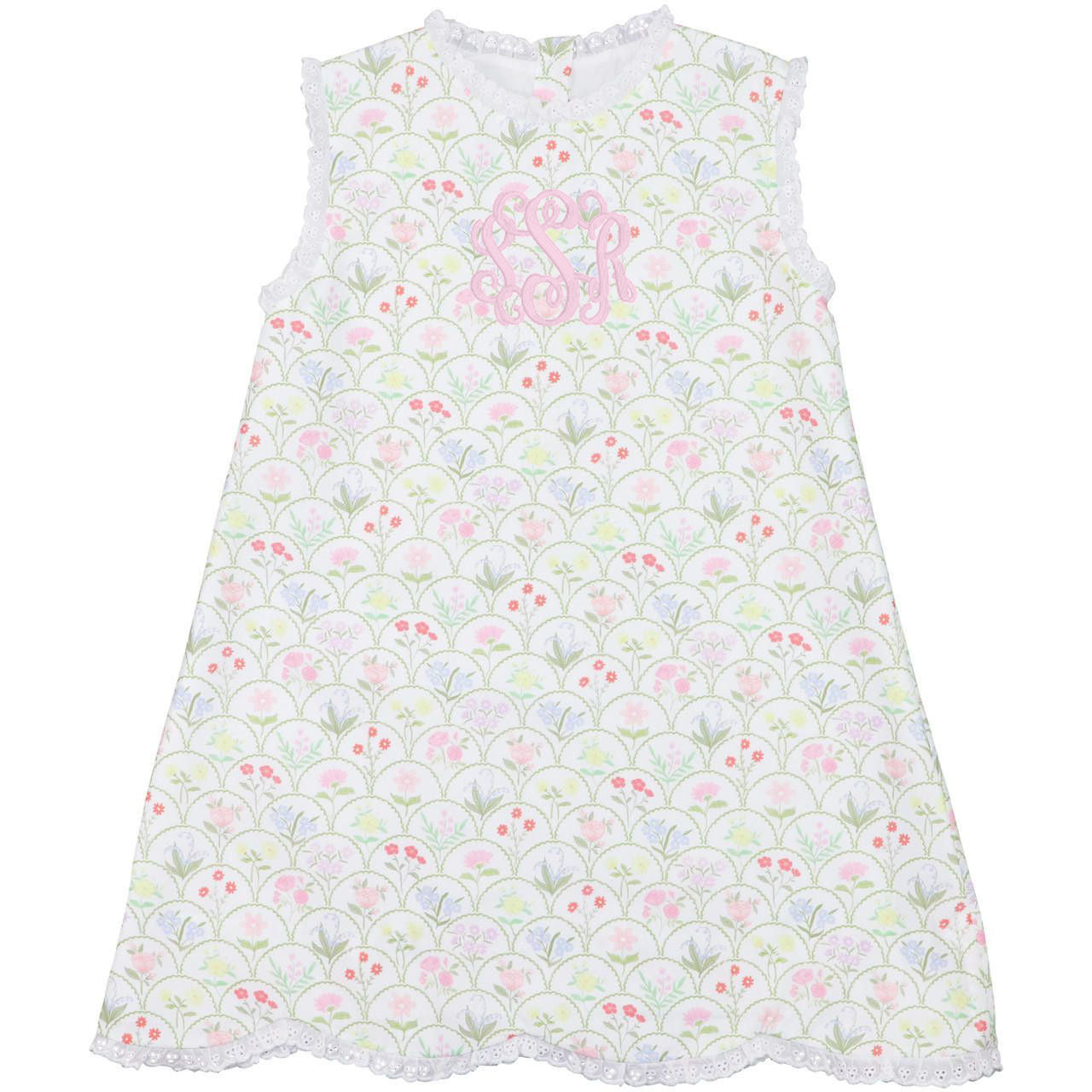 Children's dress with floral pattern and pink lettering on a white background