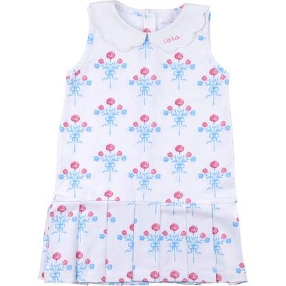 White dress with pink and blue floral pattern on a white background