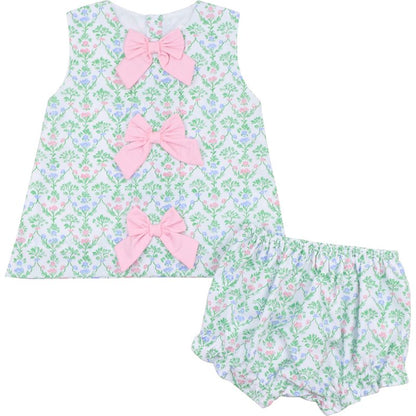 Floral baby outfit with pink bows on a white background