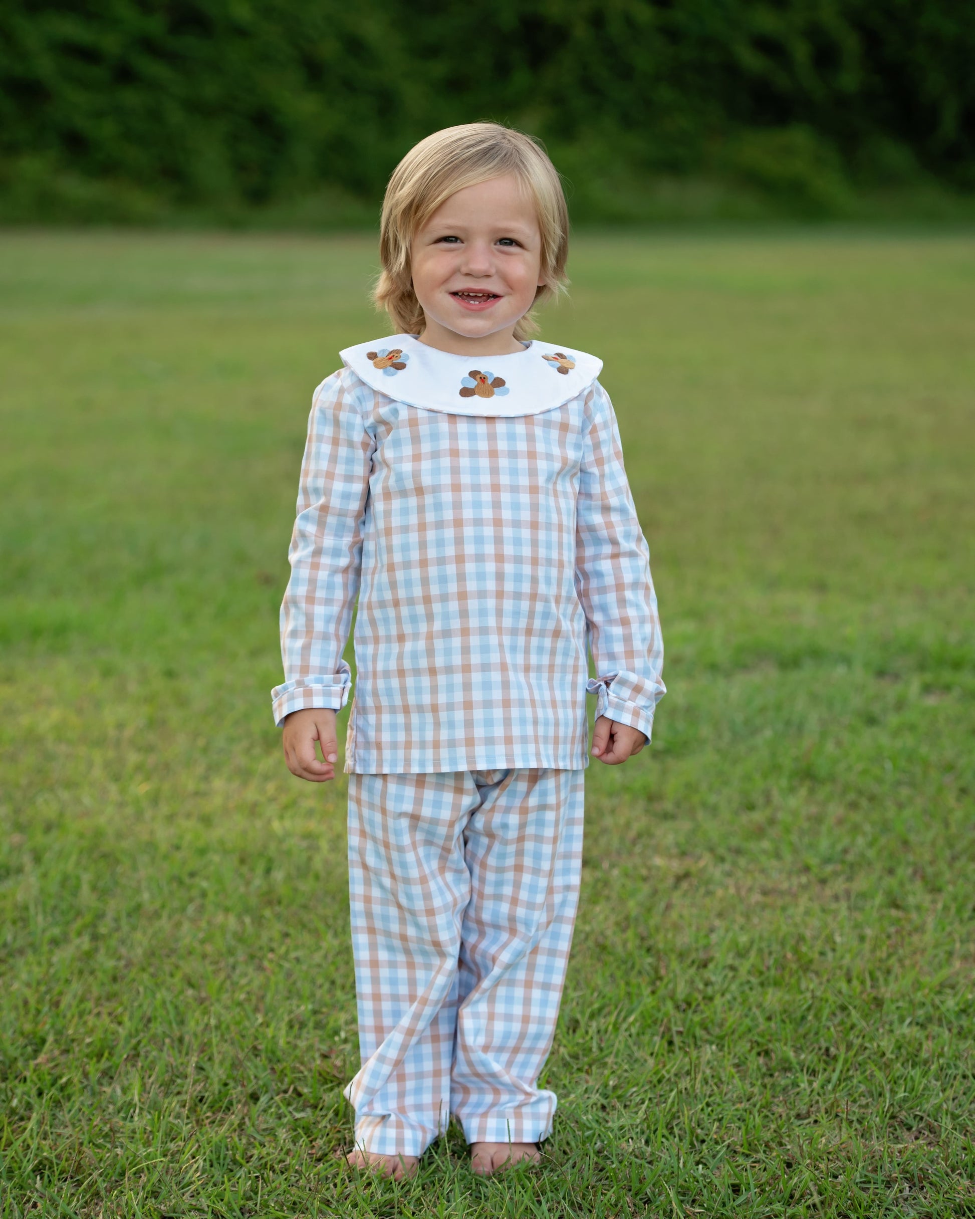 A Boy Wearing Blue And Brown Check Embroidered Turkeys Pant Set
