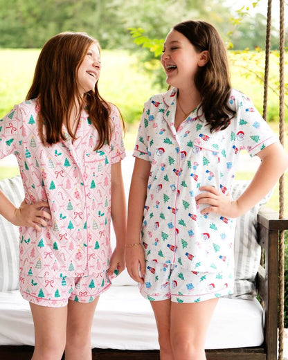 Adorable girls Christmas pajama sets with festive holiday prints and comfy short-sleeve styling. Perfect for sleepovers, Christmas morning, and matching sibling photos. Shop the cutest holiday PJs for girls today!